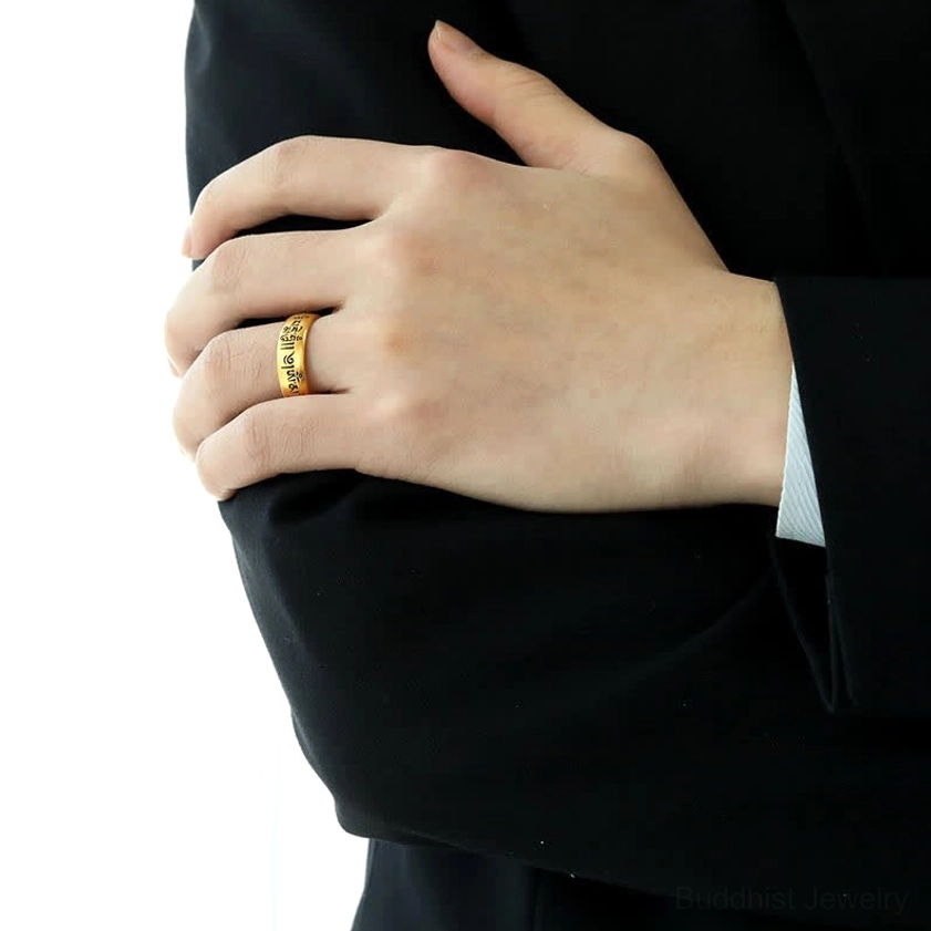 Woman wearing sacred Om Mani Padme Hum ring on index finger with black business suit, showing smooth golden aesthetic