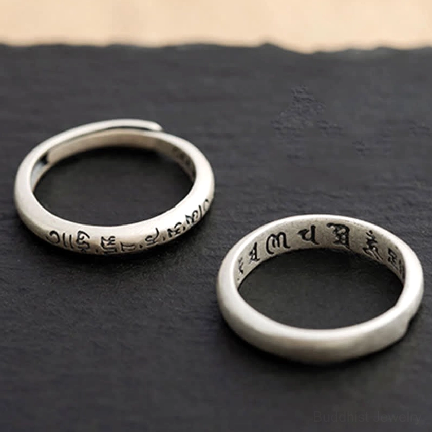 Two separate Om Mani Padme Hum sterling silver Buddhist rings top-down showing inner engraved text adjustable bands