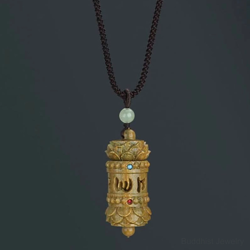 Carved green sandalwood Om Mani Padme Hum Buddhist prayer wheel pendant with inlaid colored beads and lotus design ends frontal view