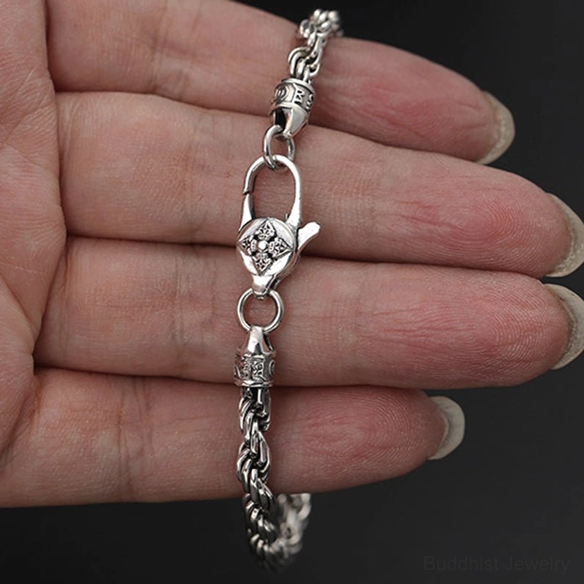 Om mani padme hum double dorje silver bracelet held on human palm showing full design and vintage finish