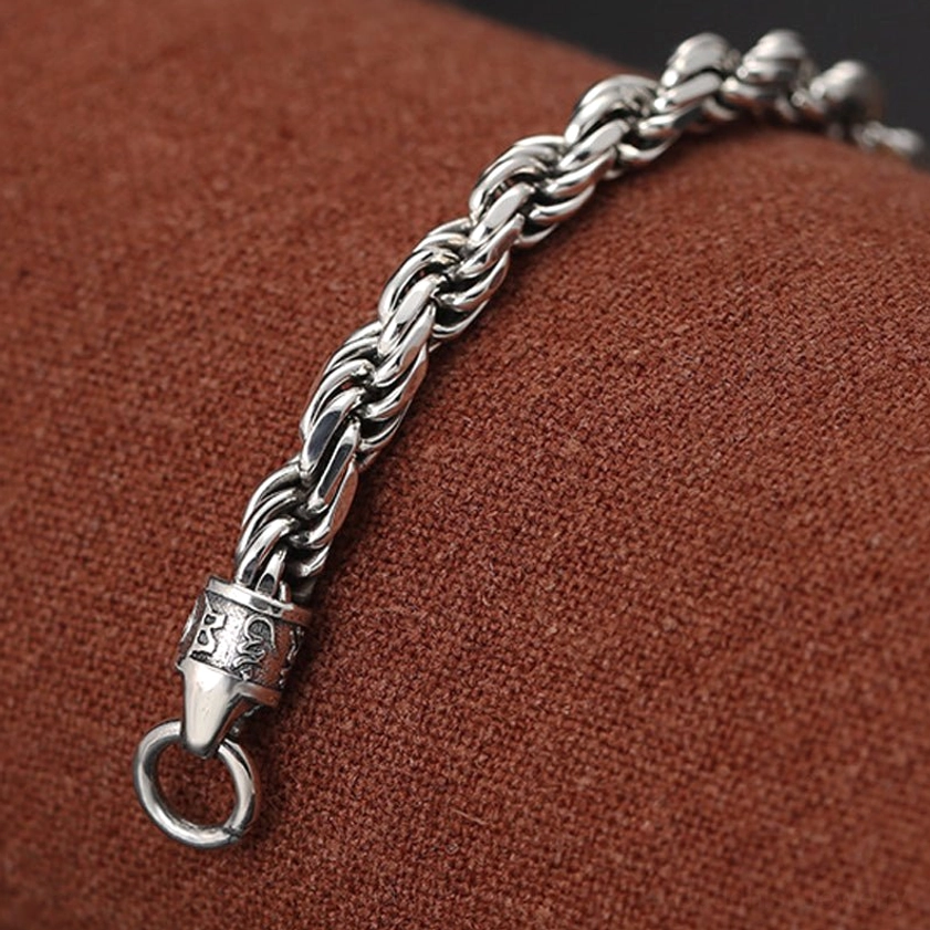 Om mani padme hum double dorje vajra silver bracelet terminal clasp close-up showing decorated jump ring fastening