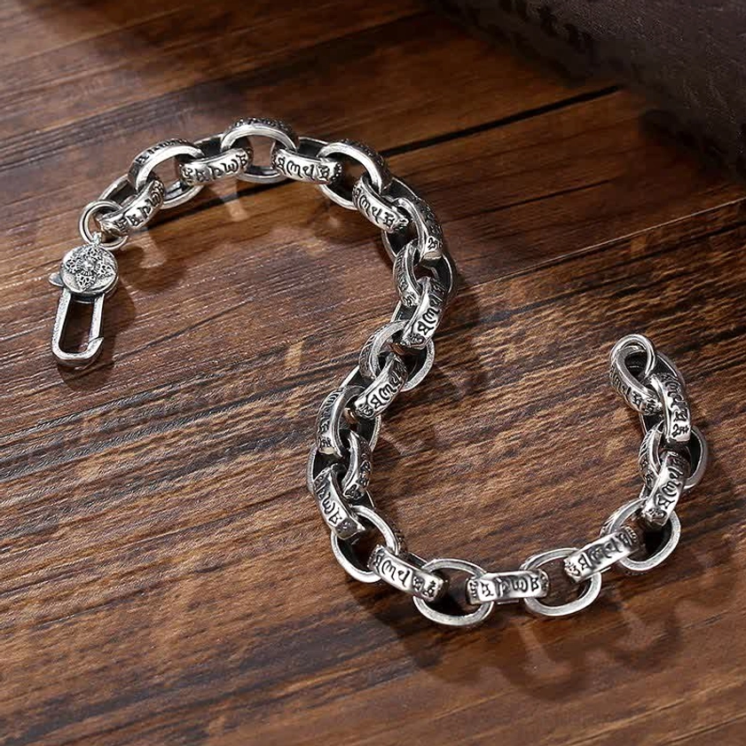Full length side view of sterling silver Om Mani Padme Hum engraved chain bracelet displayed on dark background
