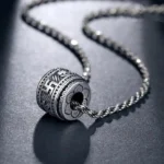 Om Mani Padme Hum silver pendant necklace with twisted chain, vintage Buddhist protection symbol close-up view