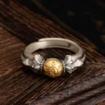 925 sterling silver Om Mani Padme Hum adjustable ring front view with engraved mantra bead on dark wooden background