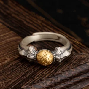 925 sterling silver Om Mani Padme Hum adjustable ring front view with engraved mantra bead on dark wooden background