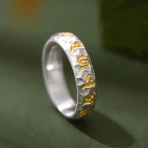 999 sterling silver Om Mani Padme Hum hammered ring with gold-plated Sanskrit mantras, side profile close-up view