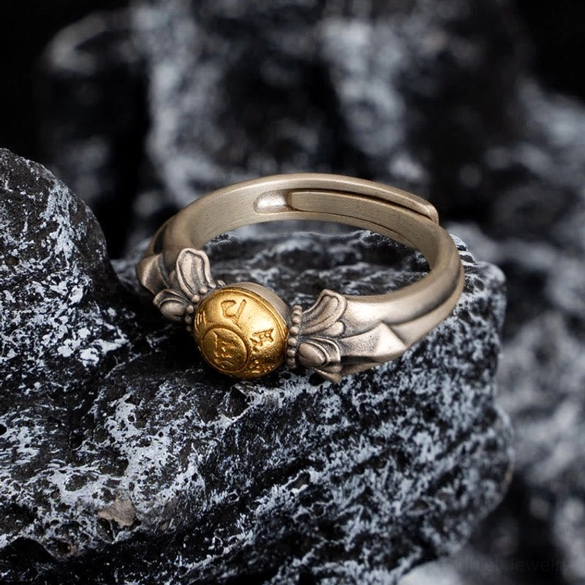 925 sterling silver Om Mani Padme Hum ring specifications showing 5.6g weight adjustable length on black background