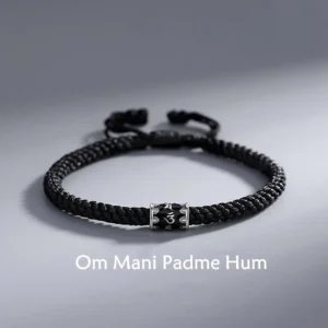 Om Mani Padme Hum sterling silver braided Buddhist string bracelet flat lay with engraved silver mantra bead
