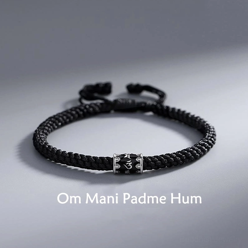 Om Mani Padme Hum sterling silver braided Buddhist string bracelet flat lay with engraved silver mantra bead