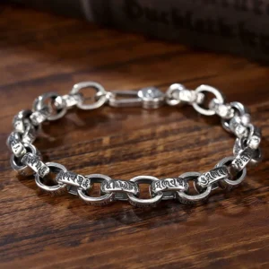 925 sterling silver Om Mani Padme Hum engraved Buddhist bracelet with lobster clasp, top-down view on dark wooden surface