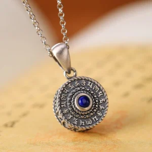 Om Mani Padme Hum sterling silver pendant with lapis lazuli stone on vintage Buddhist scripture, front view showing intricate sutra engraving and twisted silver border