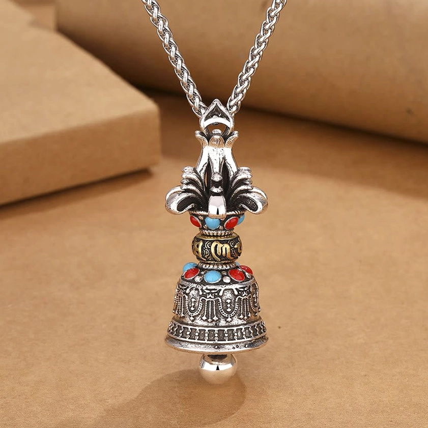 Om Mani Padme Hum Vajra Bell pendant front view showing intricate engraved patterns and retro silver tone finish