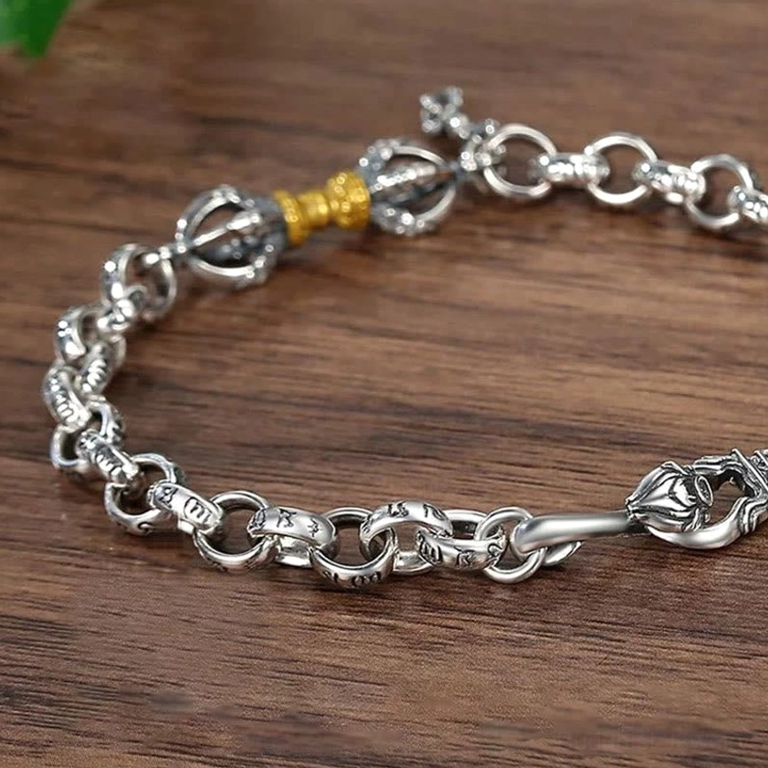 Two-tone Om Mani Padme Hum Vajra bracelet top view showing intricate metalwork and central gold vajra ornament