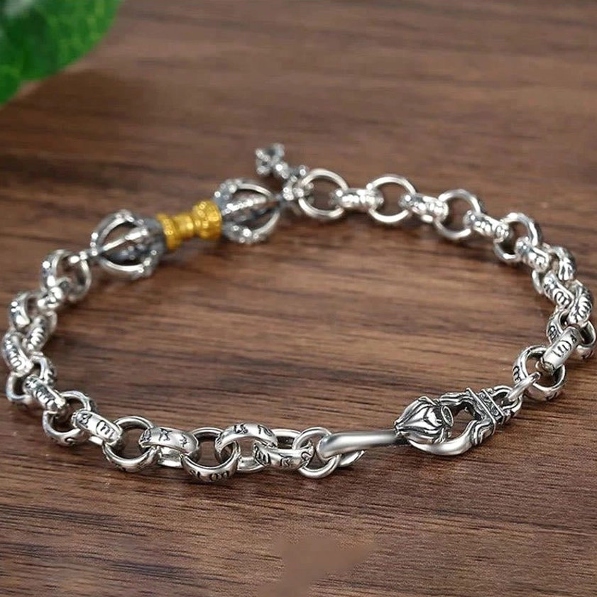 Dual-tone Om Mani Padme Hum Vajra bracelet with gold accents side flat lay view on wooden table