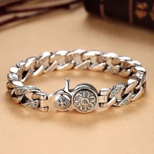 Om Mani Padme Hum Double Dorje Vajra bracelet top view flat lay showing engraved silver curb chain with round vajra emblem
