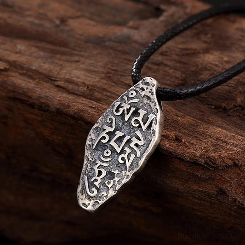 Om Mani Padme Hum Vajra necklace artistic styling with leather cord, showcasing spiritual pendant for meditation and protection