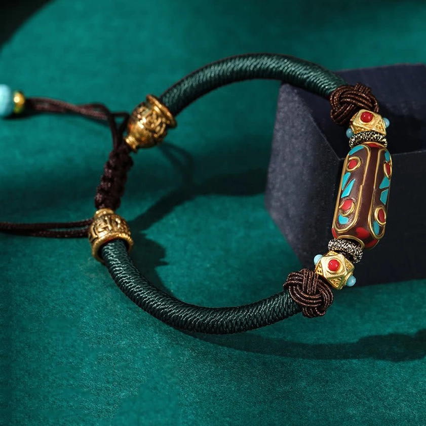 Dark green color variant of handmade Buddhist Om Mani Padme Hum braided bracelet with turquoise bead accents and copper hardware