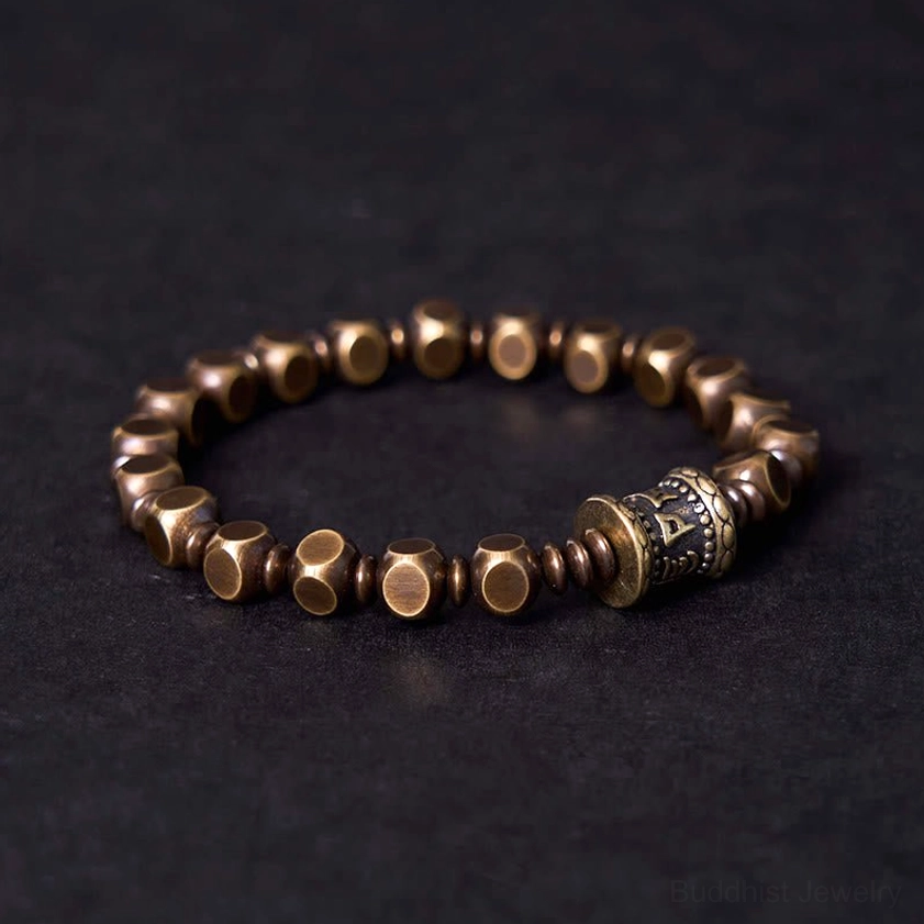 Buddhist mantra bracelet side view showing antique bronze patina and intricately carved barrel bead