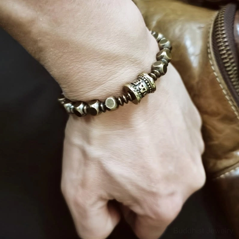 Om Mani Padme Hum mantra bracelet worn on wrist showing comfort fit and vintage brass finish