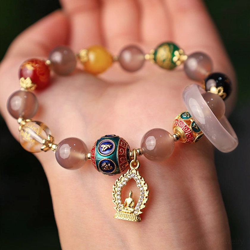 Spiritual gray agate Buddha bracelet on human hand, displaying multicolor gemstone beads and sacred mantra enamel accents with matching agate ring