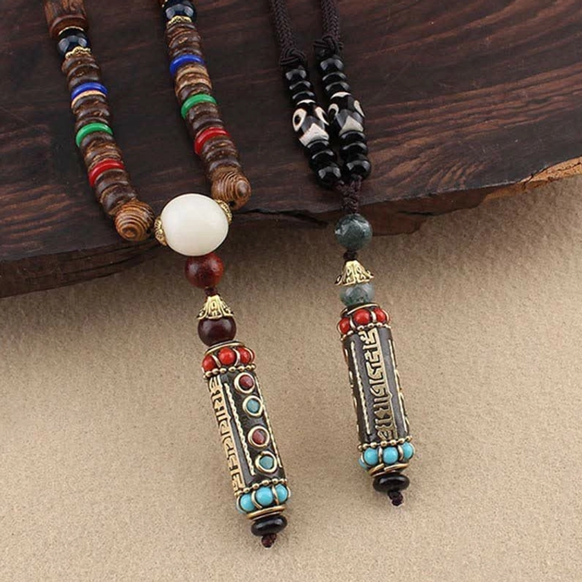 Sacred Om Mani Padme Hum necklace with turquoise and agate beads on dark wooden background, detailed view