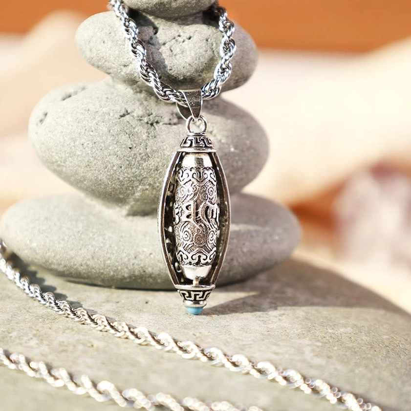 Sacred Om Mani Padme Hum necklace with twisted rope chain, vintage silver finish pendant, blue accent stone, eye-level product photography