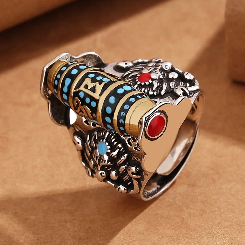 Om Mani Padme Hum Dzi bead ring with red and blue turquoise accents, embossed band details visible
