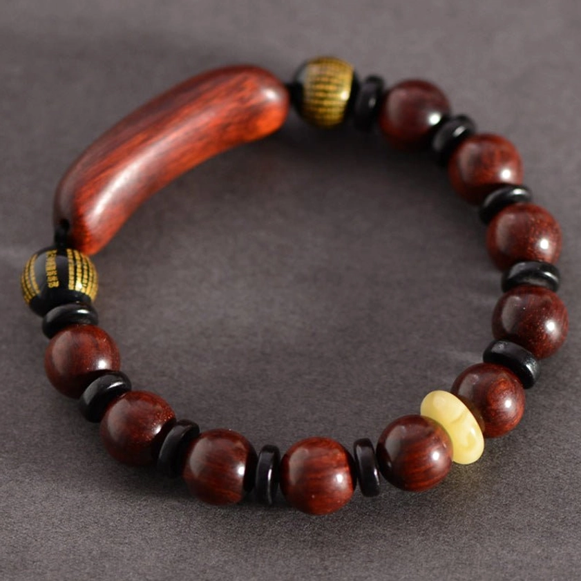 Complete red sandalwood protection bracelet laid flat showing full beaded design