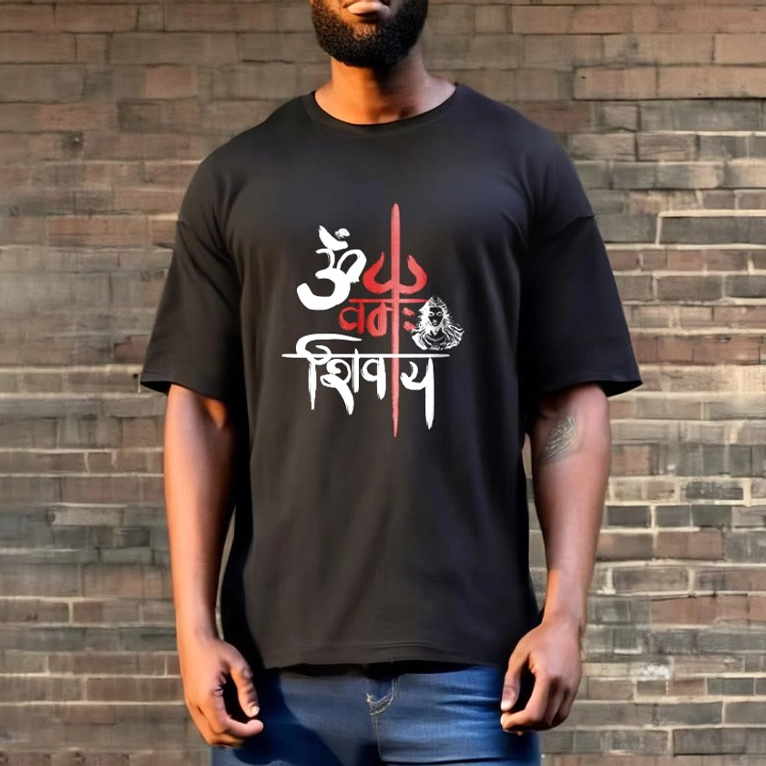 Man wearing OM Namah Shivaya black trident t-shirt with blue jeans brick wall backdrop