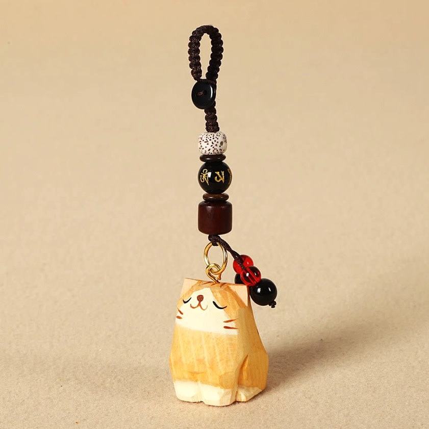 Orange cat Om Mani Padme Hum wooden keychain variant flat lay highlighting hand-carved cat design