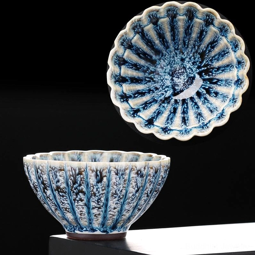 Ordinary version jian zhan lotus tea cup with mottled blue glaze on white backdrop