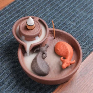 Handcrafted purple clay ox incense burner with dual slots top view, showing ceramic ox figurines and mill-style design on wooden table