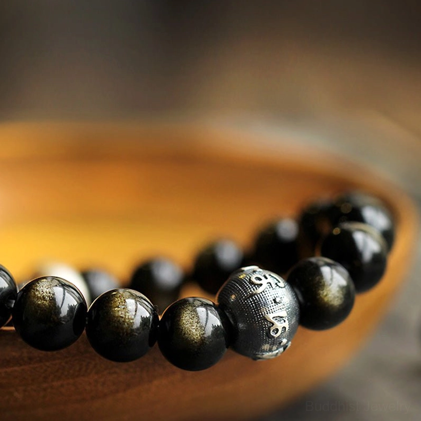 Ox zodiac natal Buddha obsidian bracelet featuring carved metal bead accent