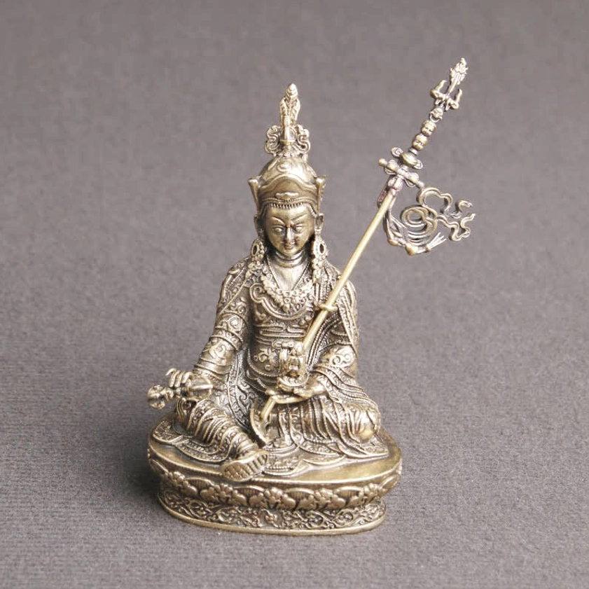 Padmasambhava Buddha statue low angle view emphasizing seated meditation pose and lotus base details