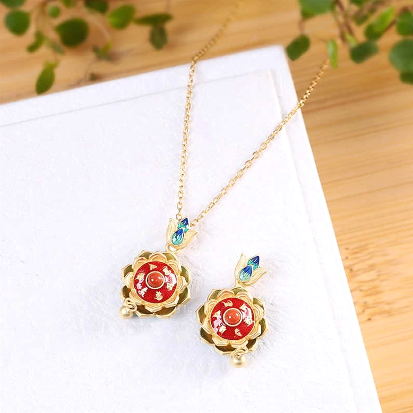 Two matching sterling silver lotus prayer wheel necklace pendants with red enamel centers and blue-green cloisonne lotus bails