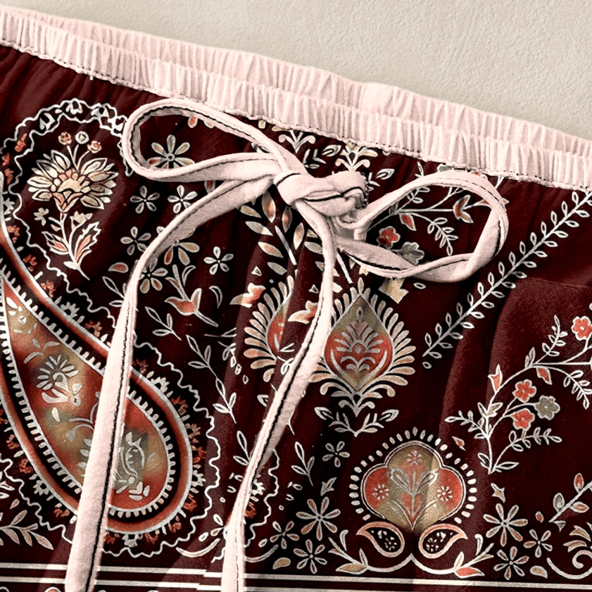 Close-up of burgundy red paisley harem pants waist with light pink drawstring detail