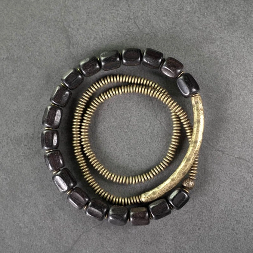 Partial view of layered Buddhist healing bracelet with ebony and copper beads