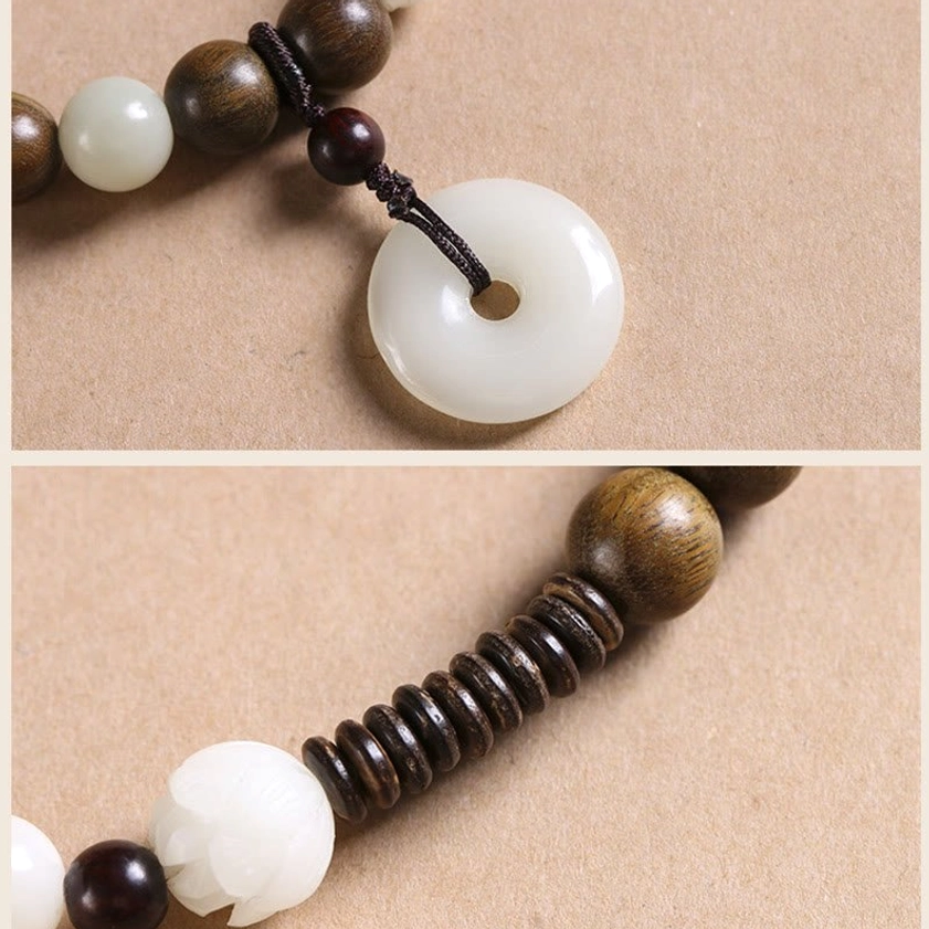 Peace buckle charm detail with dark sandalwood beads and black knot cord, showing intricate design of protective Buddhist pendant
