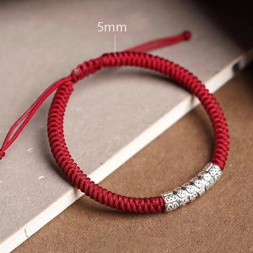 Handcrafted Buddhist string bracelet with peace and good fortune engraved silver charm