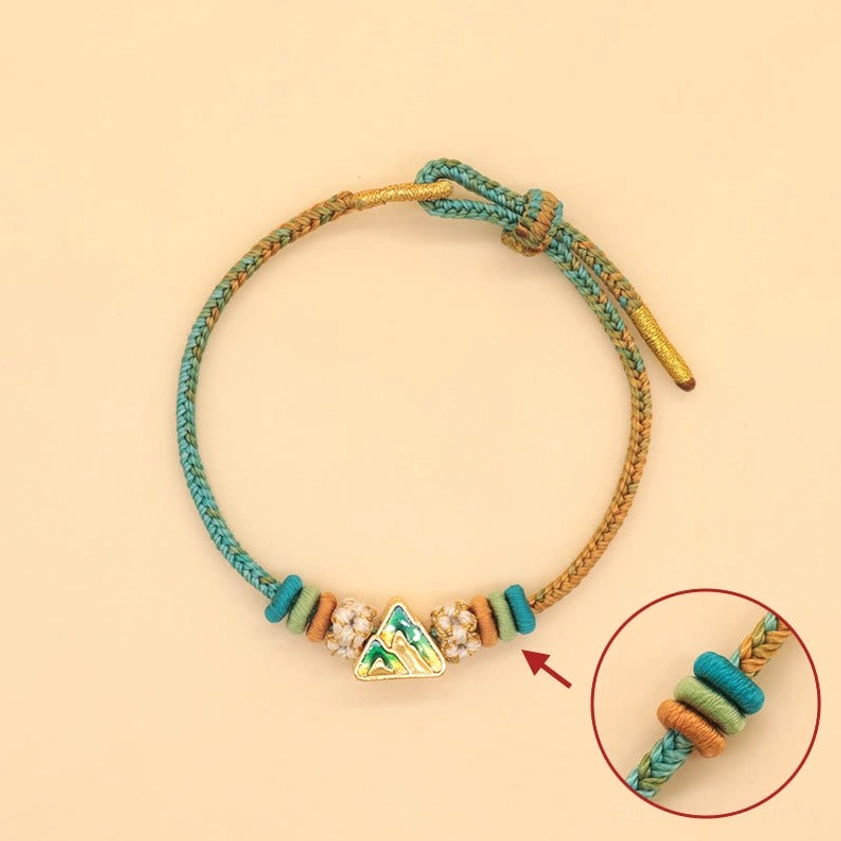 Buddhist peace knot braided string bracelet with peach blossom ornament and spiritual symbolism