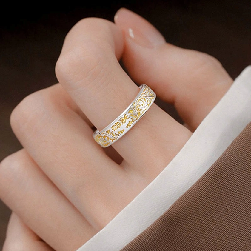 Adjustable peace and joy Buddhist ring worn on finger displaying natural fit and two-tone copper-gold finish in daily wear