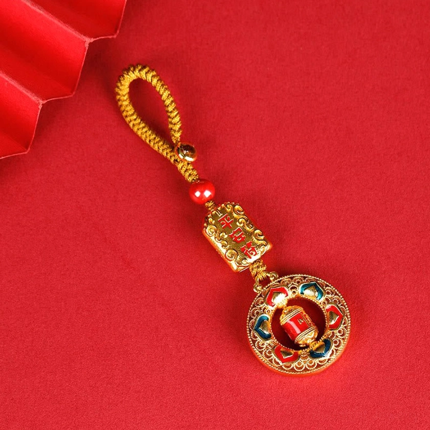 Peace Talisman prayer wheel keychain with rectangular inscribed metal charm and gold braided lanyard