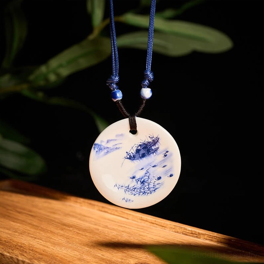 Peach blossoms ceramic pendant necklace hanging view showing delicate floral design on dark background