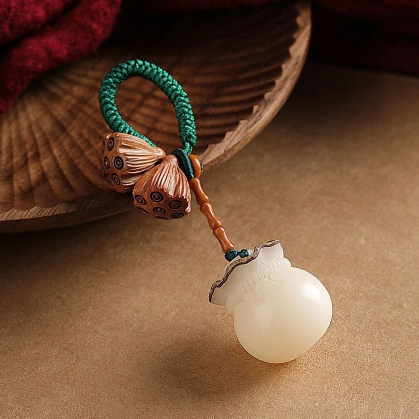 Handmade Buddhist keychain with peach wood lotus pods and white fortune pendant charm