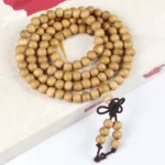 6mm peach wood 108 bead Buddhist prayer mala with Chinese knotted tassel on book