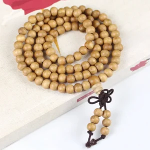 6mm peach wood 108 bead Buddhist prayer mala with Chinese knotted tassel on book