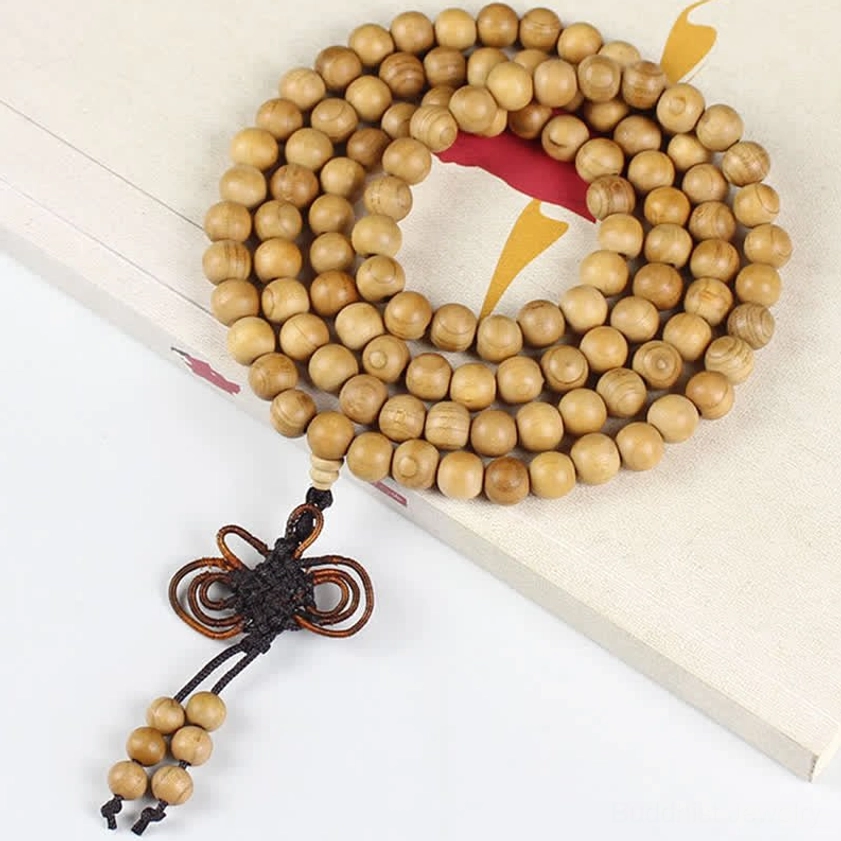 Peach wood Buddhist mala with ornate Chinese knot tassel and red decorative paper