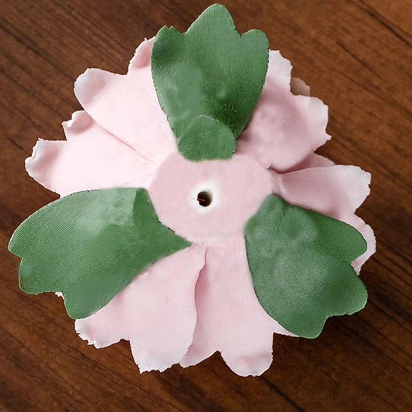 Back view of pink peony incense holder with decorative green leaves and center hole