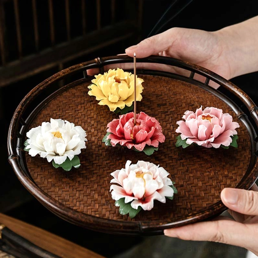 Five mixed-color peony incense holders set on bamboo tray, hands holding collection