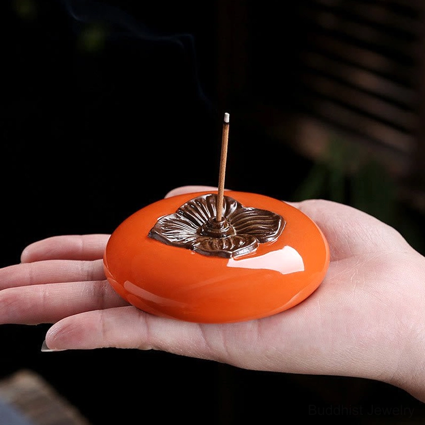 Persimmon ceramic incense burner front view showing complete shape and bronze floral embellishment details on glossy surface
